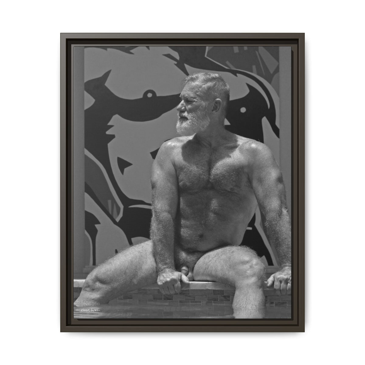 A framed black and white art print featuring a muscular bearded man sitting on a ledge against a stylized graphic background, enclosed in a dark frame.